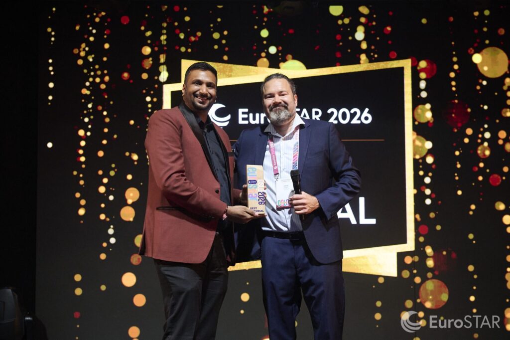 Rahul Parwal holding the EuroSTAR 2026 Best Tutorial Award on stage in Oslo